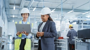 Portrait Two Female Employees Hard Hats